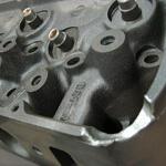 Typical cast cylinder head (427) damage due to mishandling.